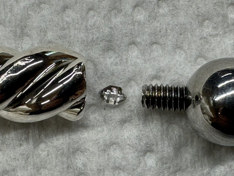 Silver Dowsing Pendulum with a Herkimer Diamond Crystal placed within the body.